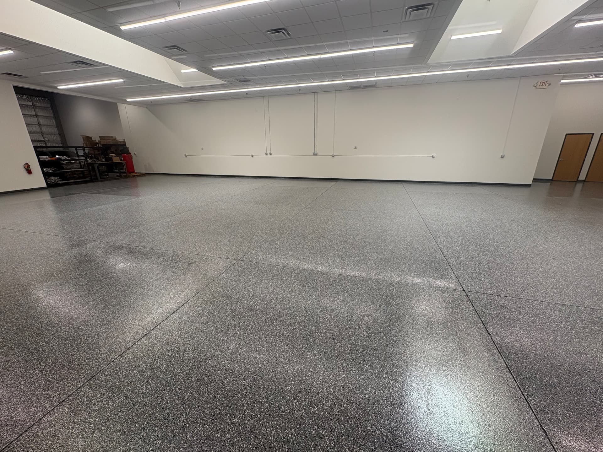 Commercial warehouse or showroom floor coated by The Garage Monkey