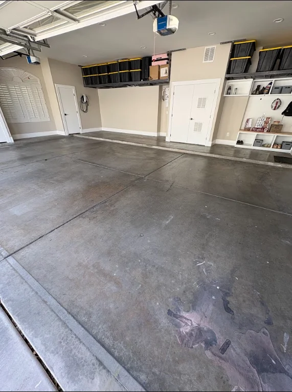 A Gilbert, AZ garage floor mid-preparation, showing a diamond-ground concrete surface with an open, uniform profile and cleaned edges ready for coating. The slab shows the matte, slightly textured finish that results from mechanical grinding on a residential garage floor.
